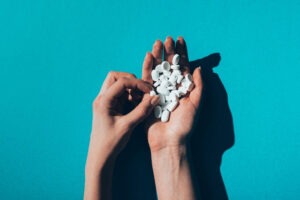 hand holding Xanax, highlighting the need for treatment and support