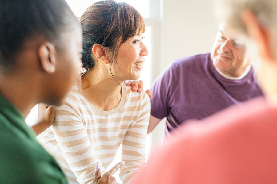 A woman being comforted in group therapy