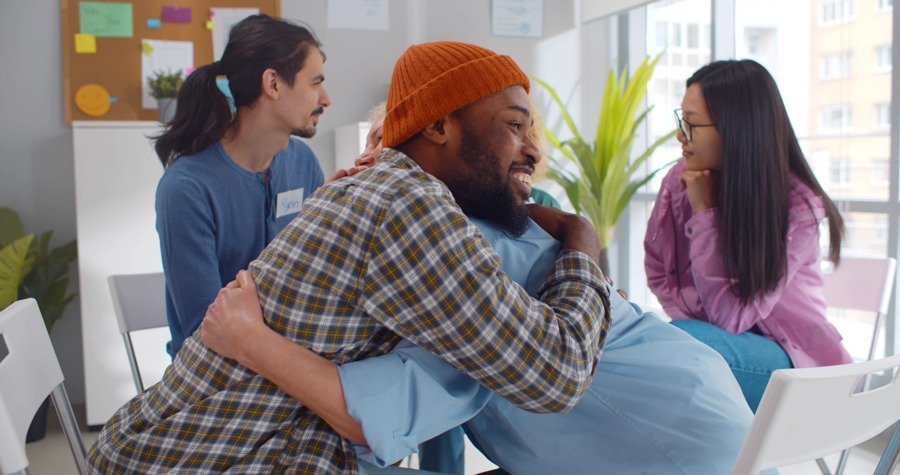 a man and woman hugging in recovery