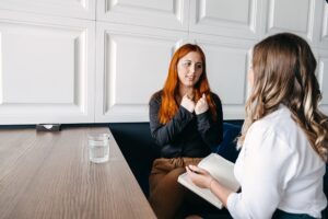 two women discussing rehab covered by insurance