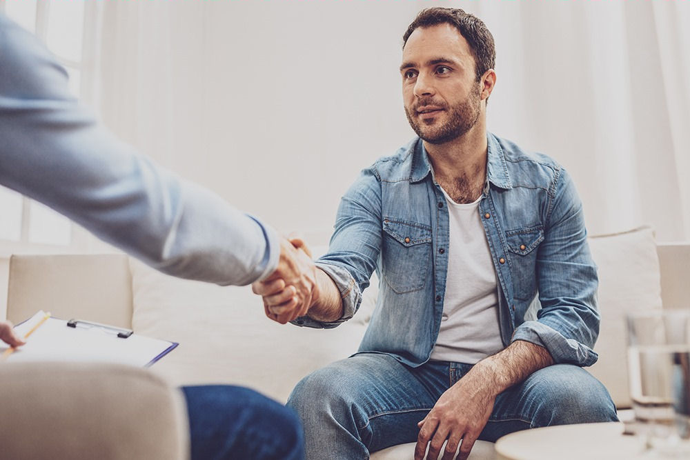 a man shaking hands with therapist