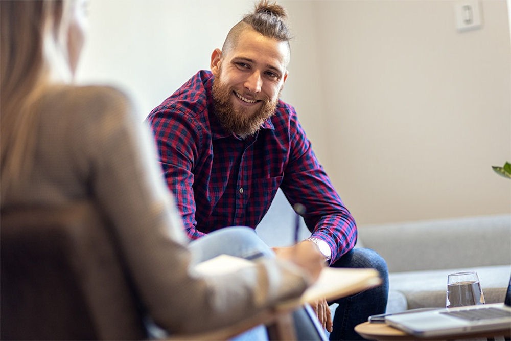 a man smiling in therapy