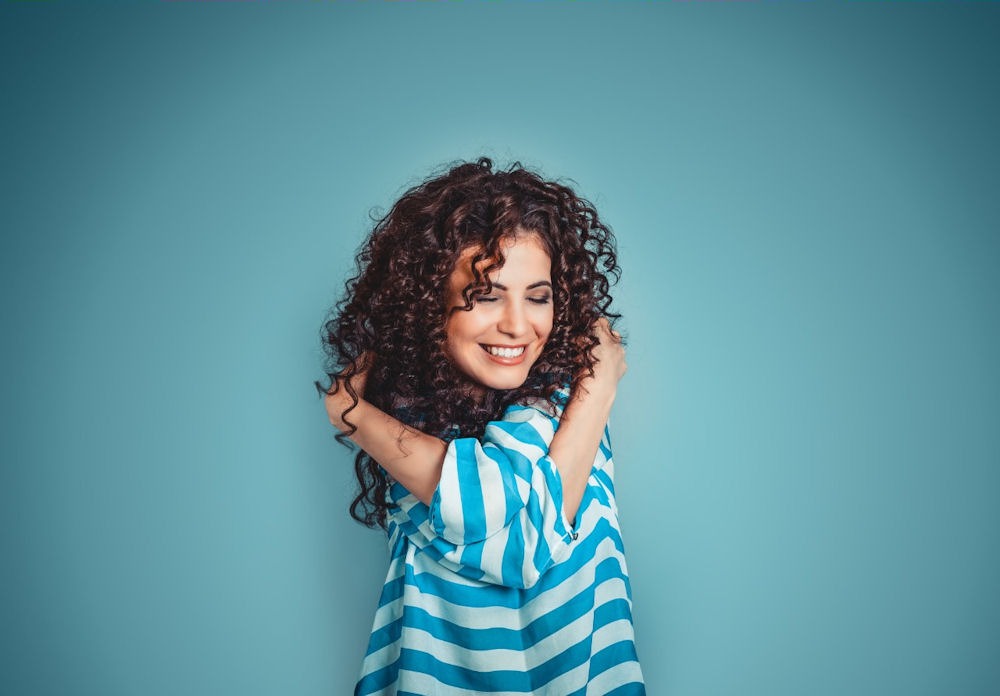 a woman hugging herself for self care