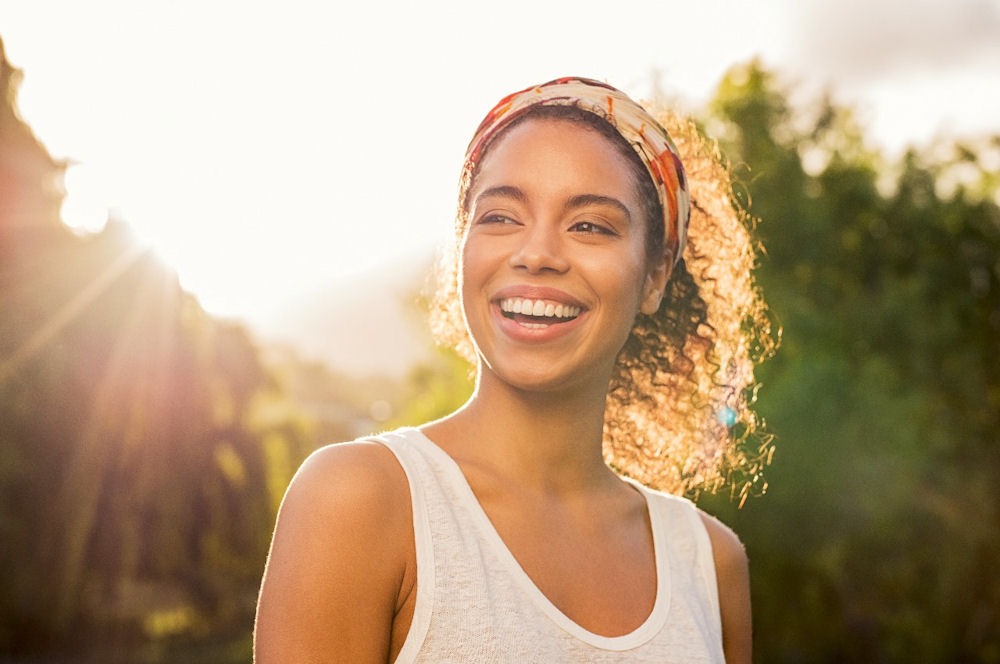 a woman smiling in nature
