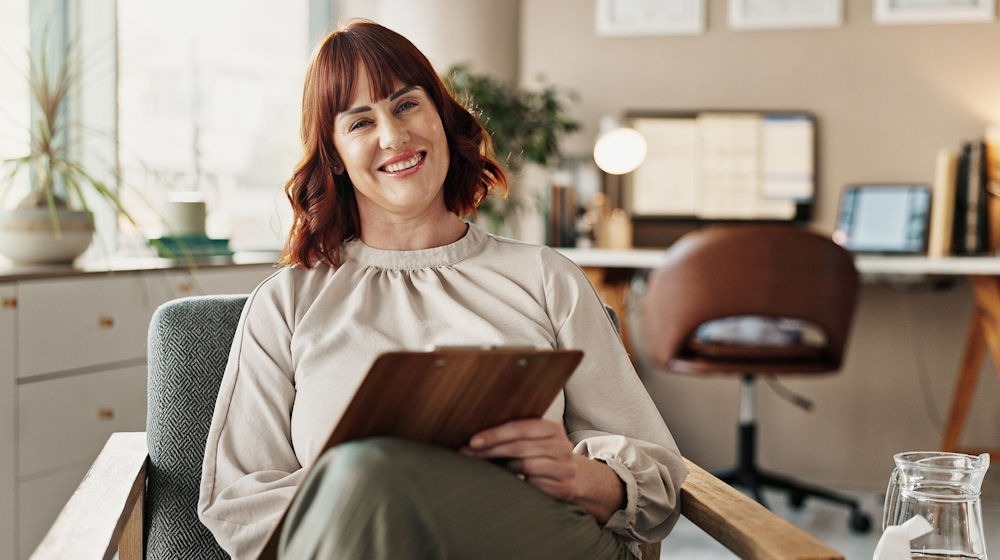 therapist sitting in chair smiling