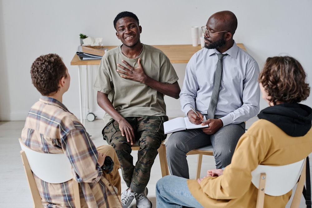a group of people sitting in circle during therapy