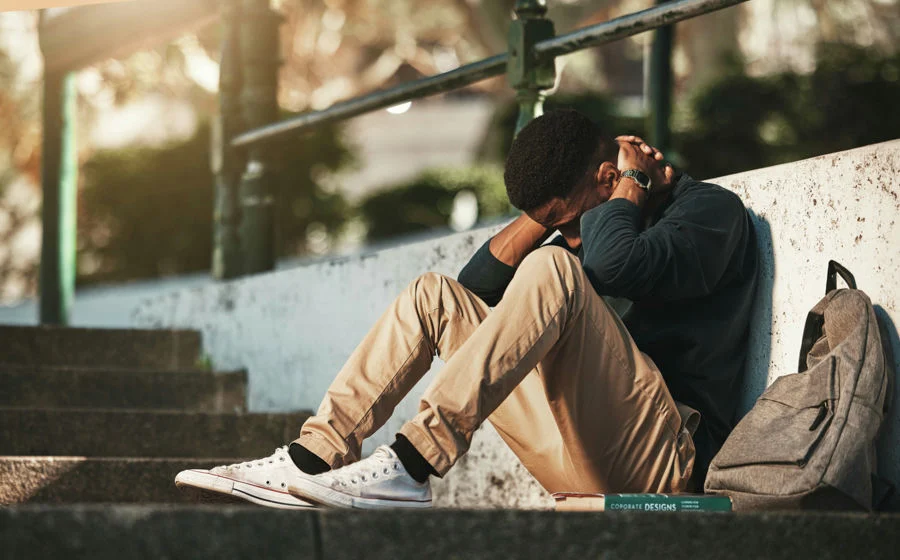 man with head down reflecting on social anxiety disorder