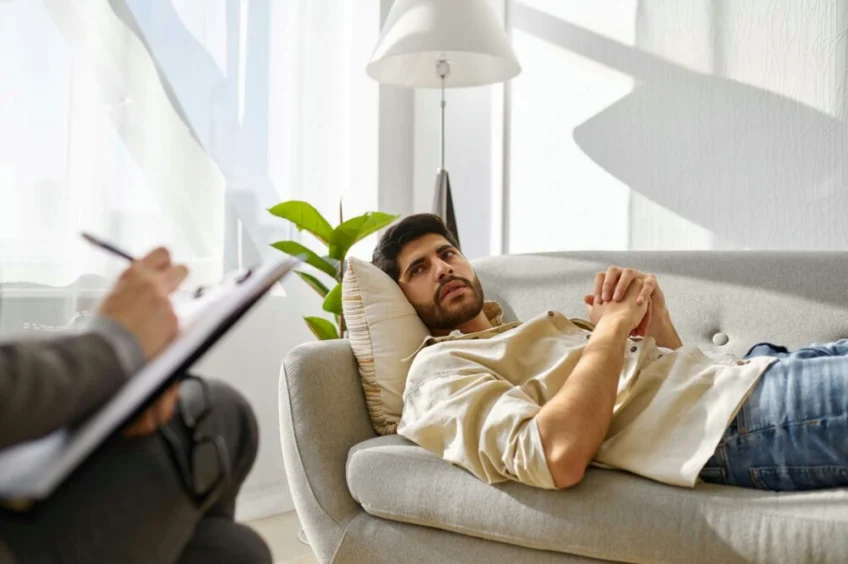 man in inpatient mental health treatment guided by therapist