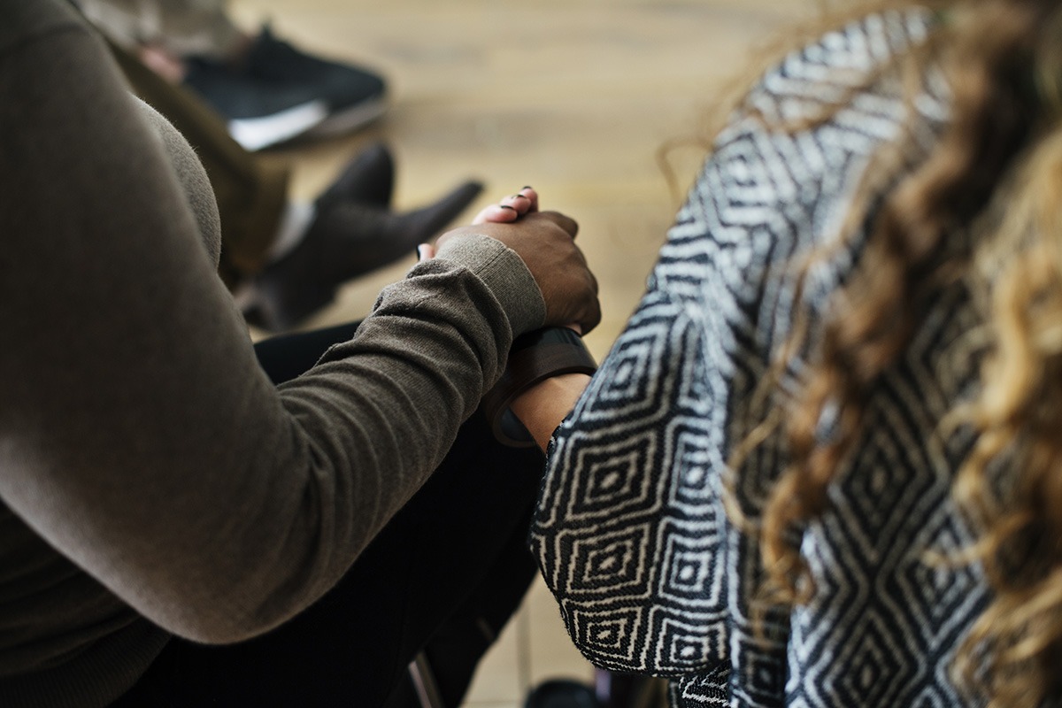 pair holding hands in addiction recovery