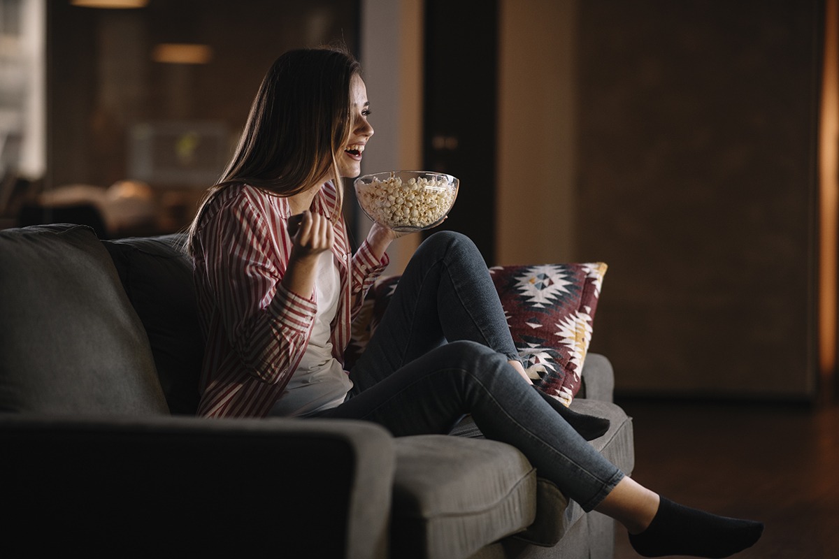 woman on couch using distraction from cravings