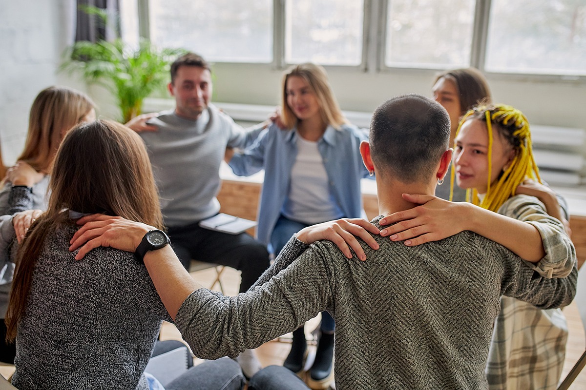 group of friends showing support for addiction recovery