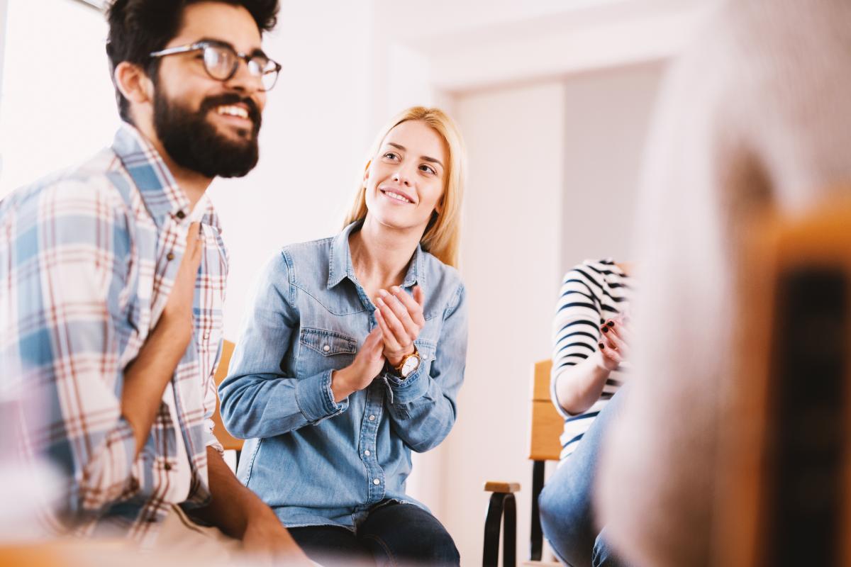 group clapping for man after choosing a detox center