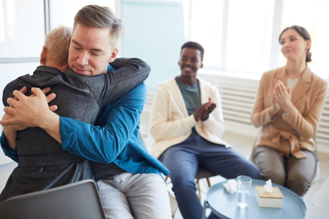 a person hugging another in therapy