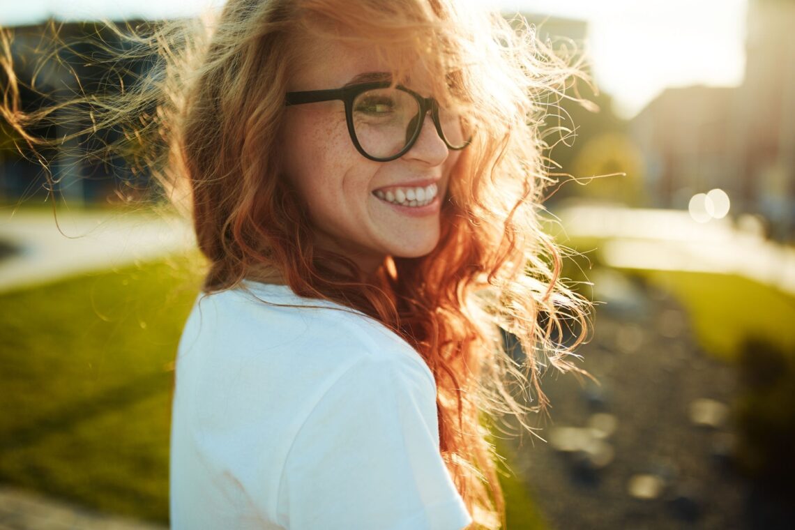 a woman smiling in nature