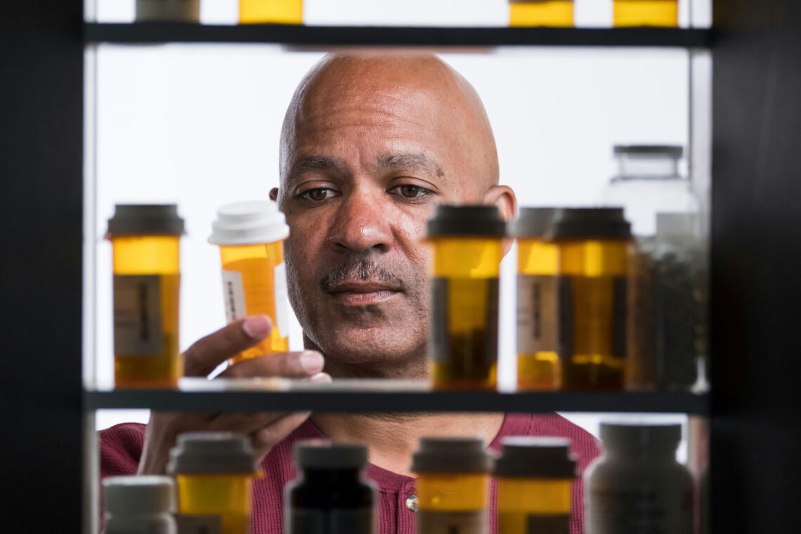 a-man-staring-at-pill-bottle