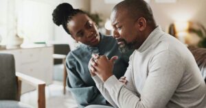man on the verge of tears in therapy, coping with secondary traumatic stress